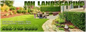 A backyard patio with a hot tub and outdoor furniture. The patio is paved with stone and surrounded by a grassy lawn. There is a walkway leading up to the patio. There is also text overlayed on the image that reads MH Landscaping in the top right. Additional text in the bottom left reads "Brick Pavers Driveways. Steps. Retaining Walls Patios & More! 262-745-6389.